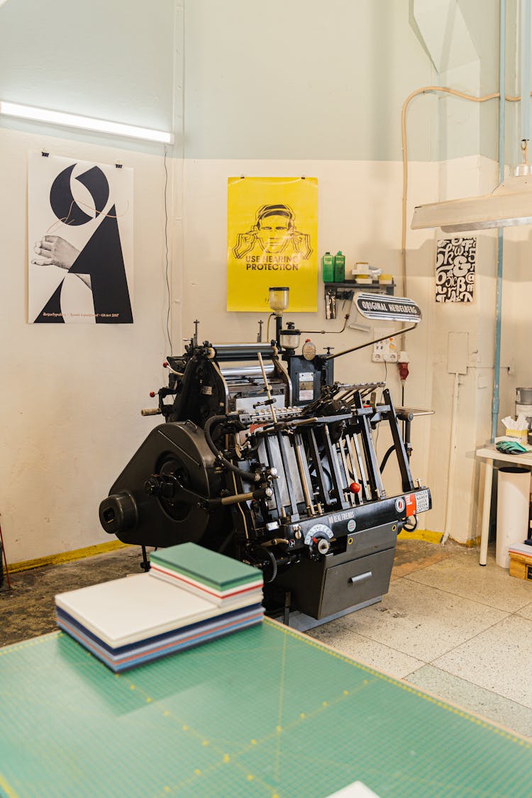 View Of Graphic Designers Studio With A Press And Posters 