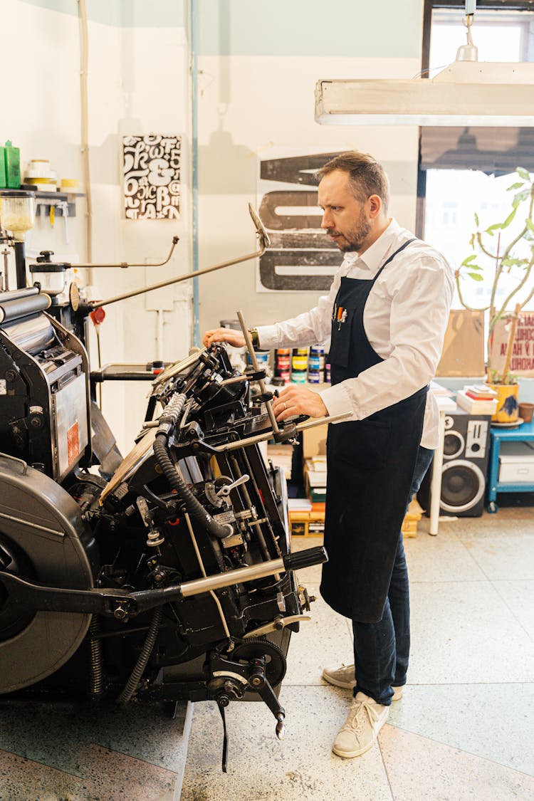 Man Operating Industrial Printer