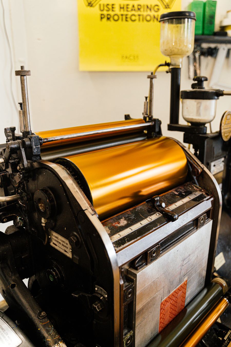 Close-up of vintage printing press rollers and mechanical components