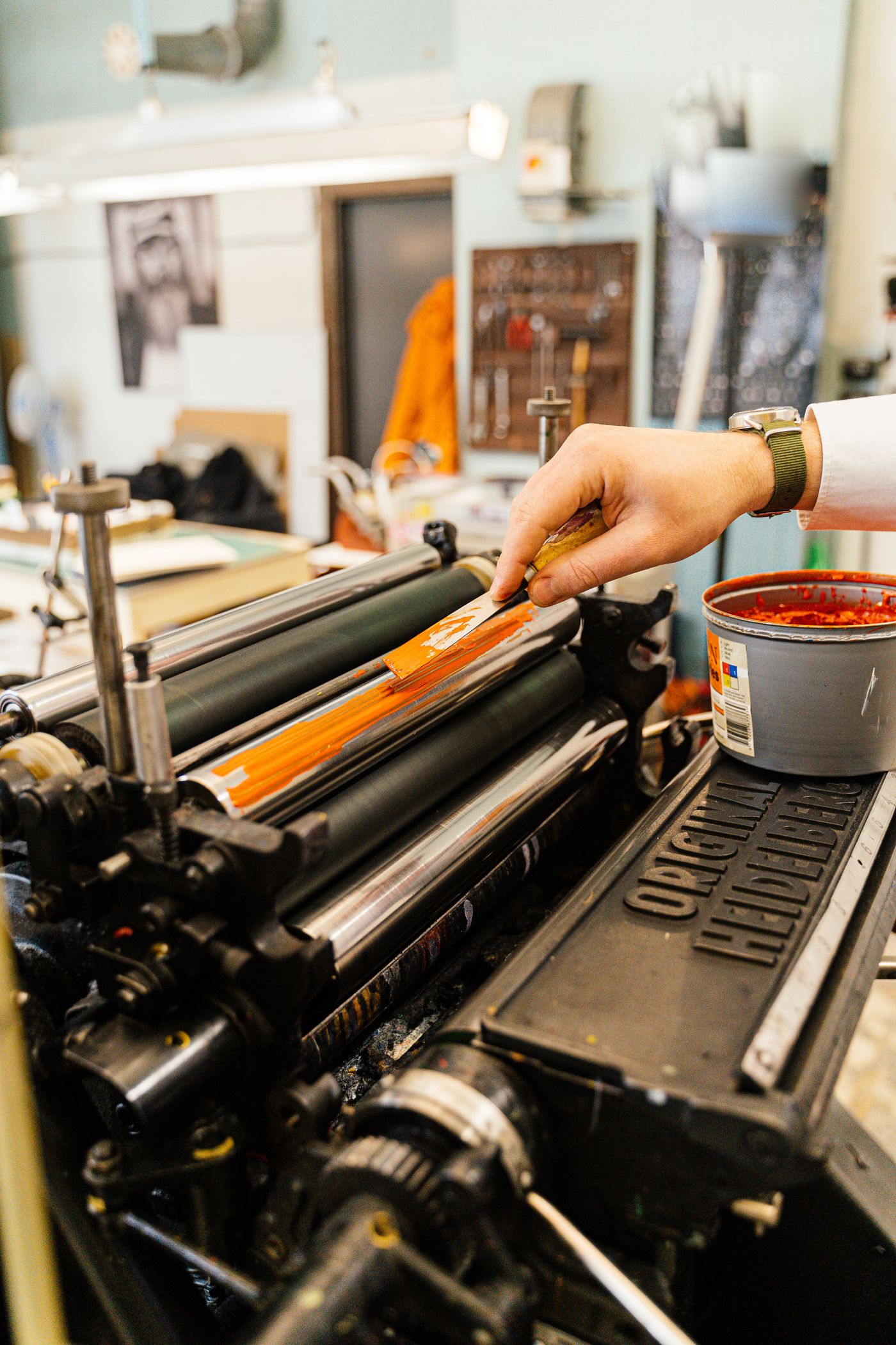 Hand inking a vintage printing press
