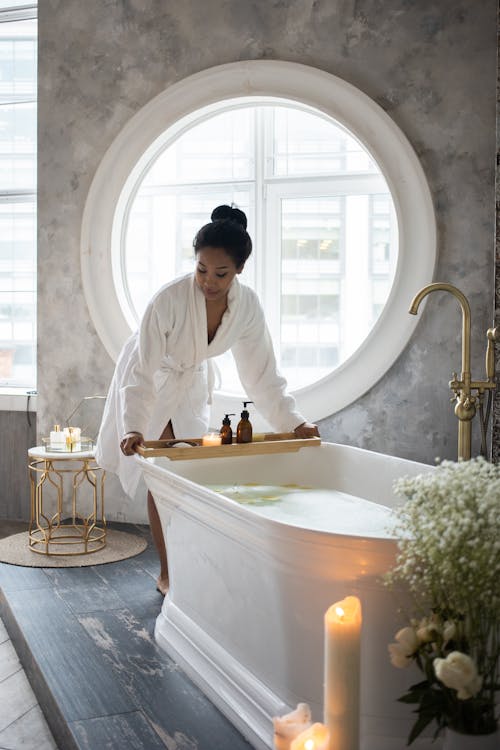 Black woman preparing for spa treatment in bathroom