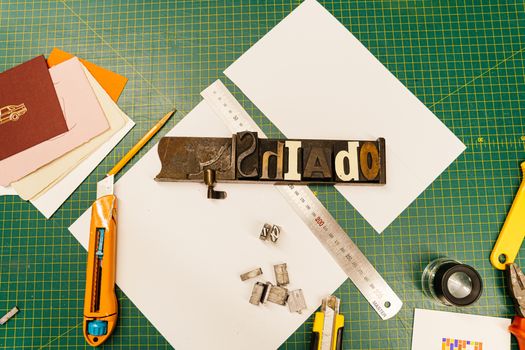 A top-view image of letterpress tools and paper materials for creative printmaking projects.