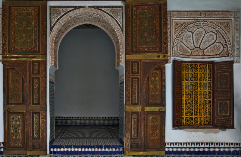 Ornate carved arches and painted doors of a historic palace — photo by Tom D'Arby on Pexels