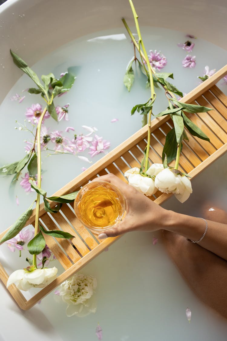 Woman Holding Glass With Wine While Taking Bath