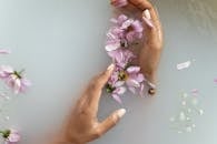 Woman holding flowers in hands in water