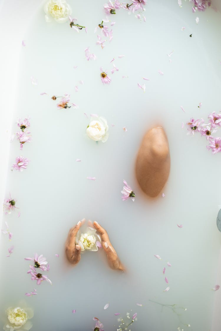 Faceless Lady In Milk Bath With Flower Petals