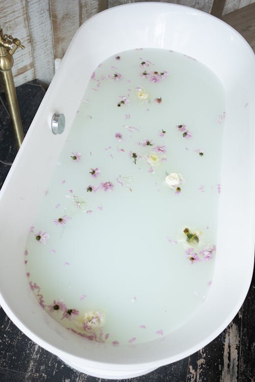 Free Bathroom with white water and flower petals Stock Photo
