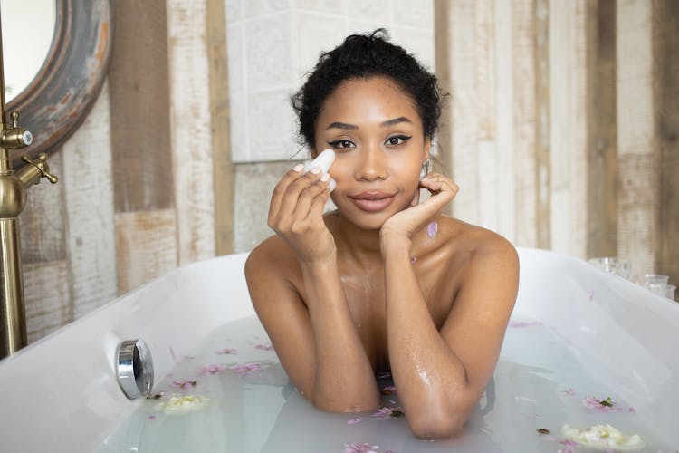 Sensual Black Woman Doing Massage Of Face In Bathtub