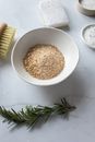 Organic scrub in bowl near brush for dry massage