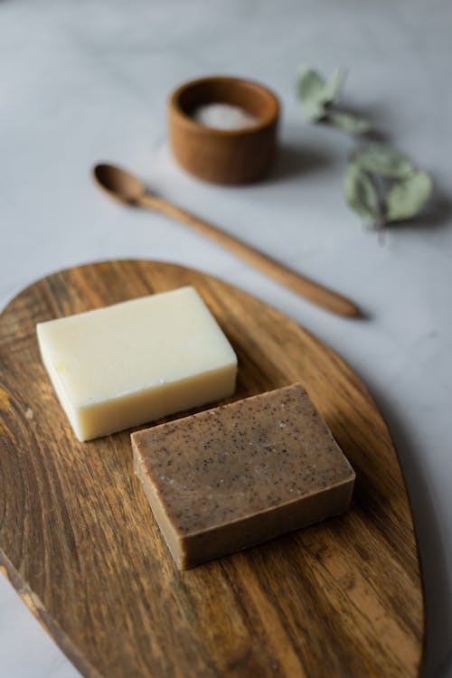 Free From above of aromatic natural handmade soap near timber spoon and scrub with salt Stock Photo