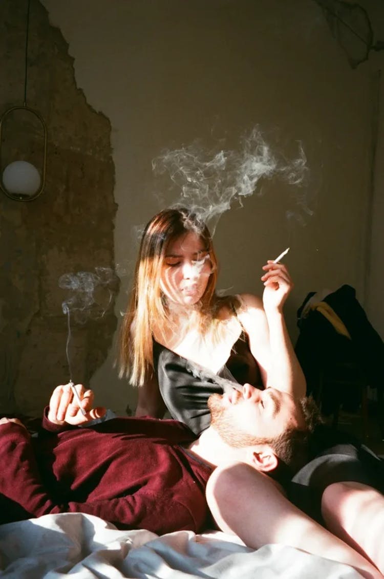 Photo Of A Couple Smoking Cigarettes Together