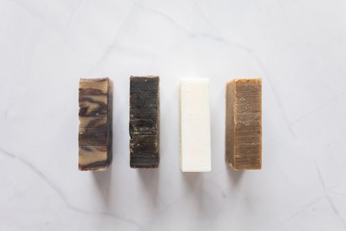 Free Top view of composition with handmade aromatic soap placed on white background in bathroom Stock Photo