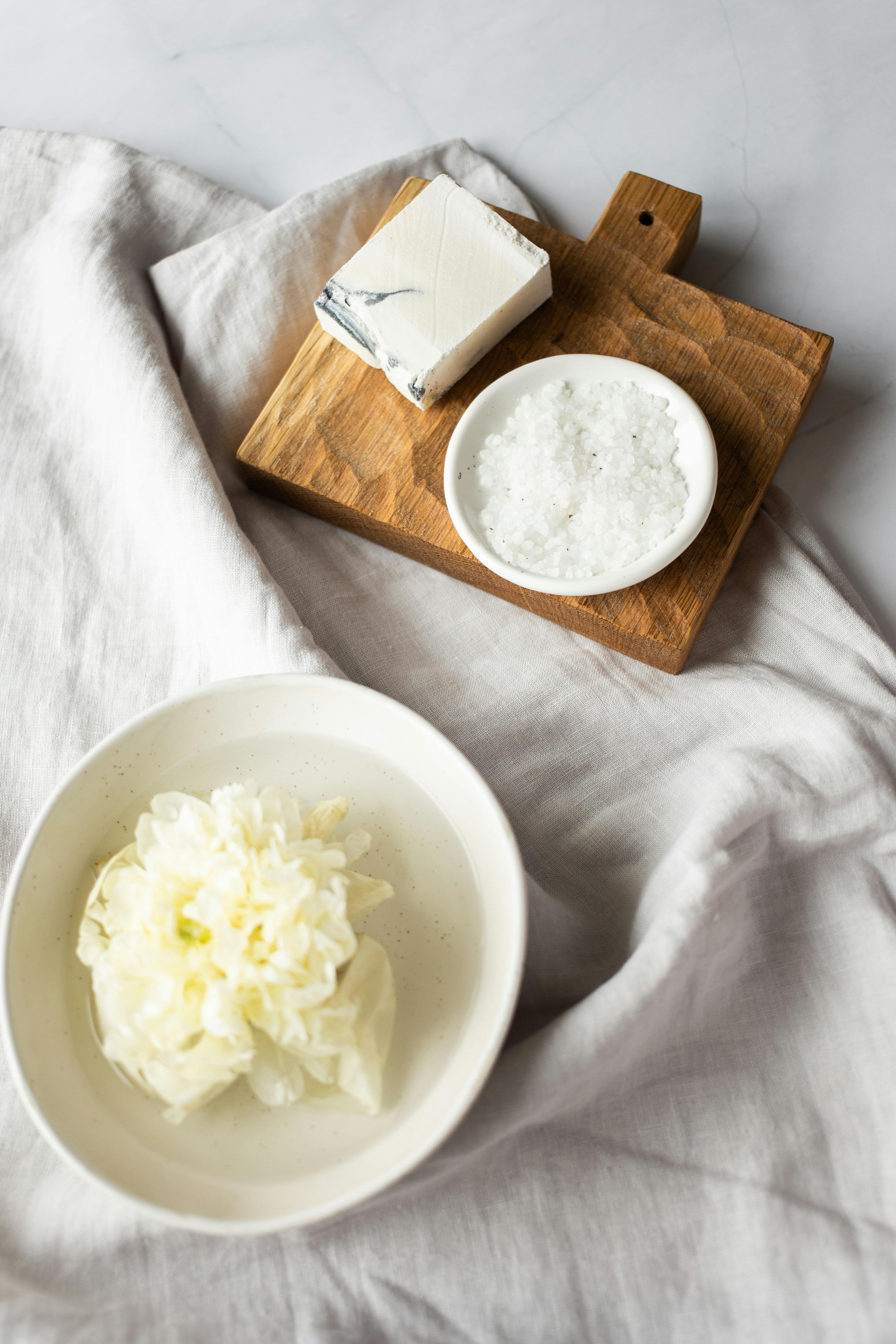 different organic scrubs in plates near handmade soap