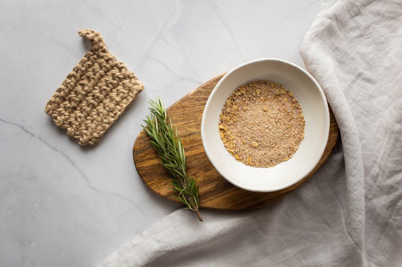 Ground oatmeal powder with dried flowers for sensitive skin bath soak