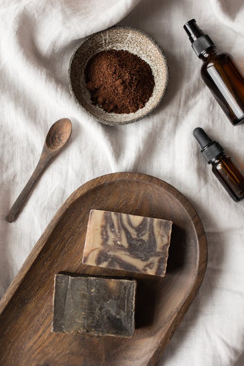 Free Handmade soaps and bowl with coffeee placed on table Stock Photo