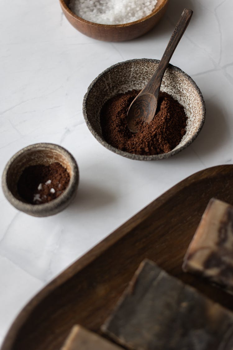 Bowl With Coffee Scrub Placed On Marble Table