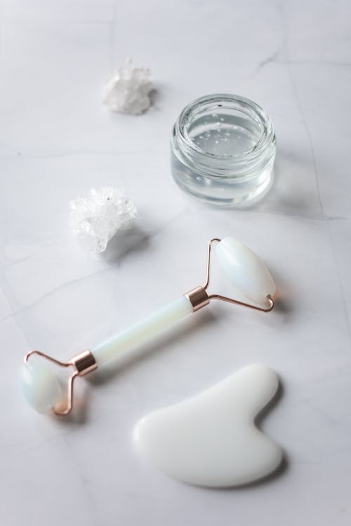 Facial massage tools placed on marble table