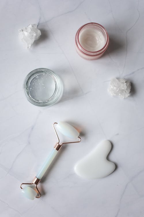 Spa supplies for skincare procedures placed on marble table