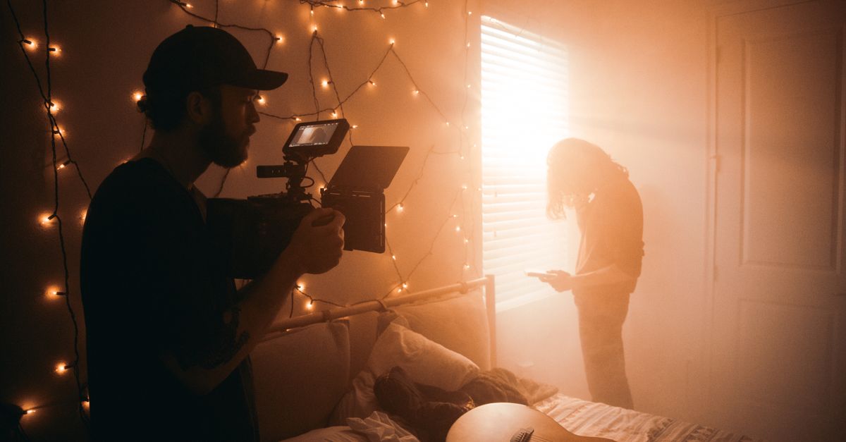 intimate indie artist recording in a home studio, warm lighting