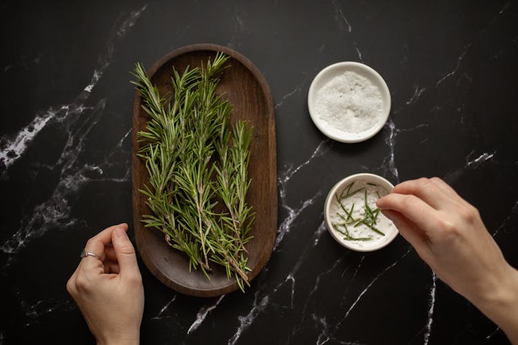 Female Preparing Natural Scrub With Rosemary And Salt