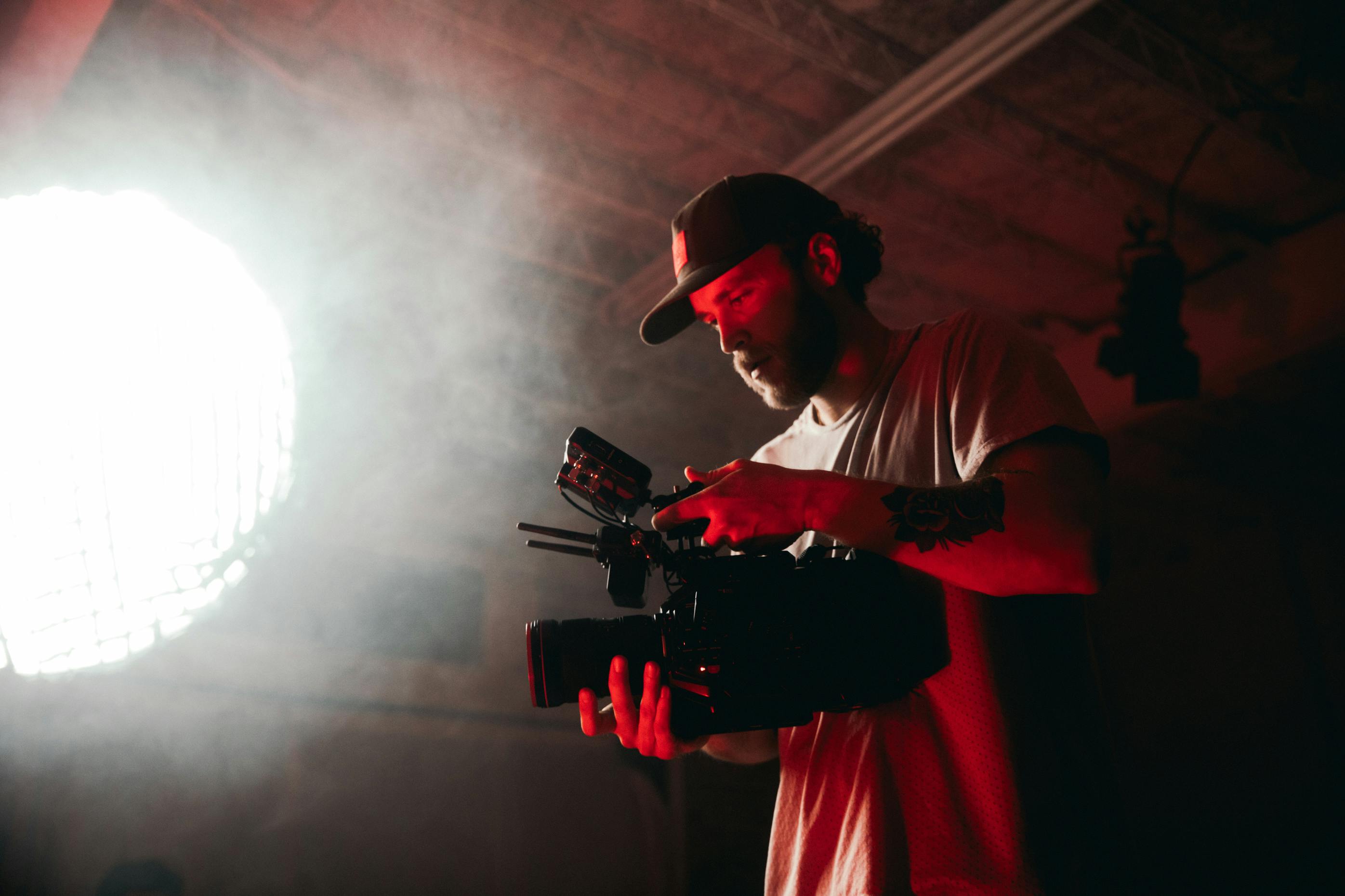 photo of a man filming near smoke