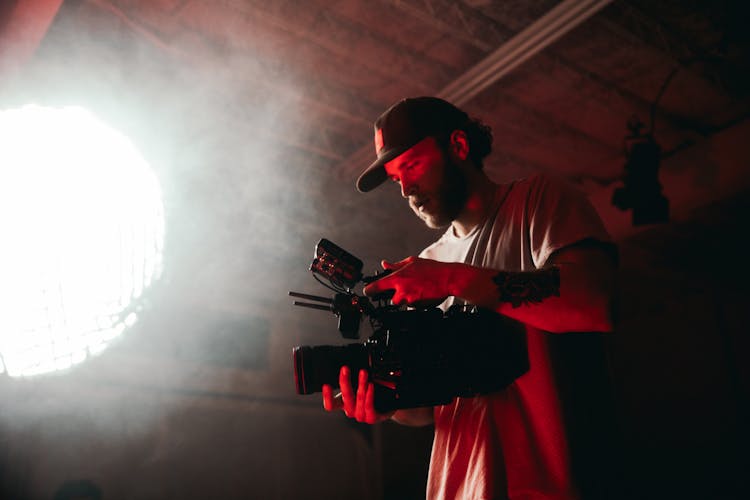 Photo Of A Man Filming Near Smoke