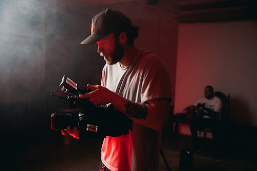 Photo of a Videographer with an Arm Tattoo Filming