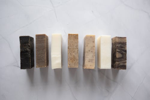 Collection of natural soaps placed on marble table