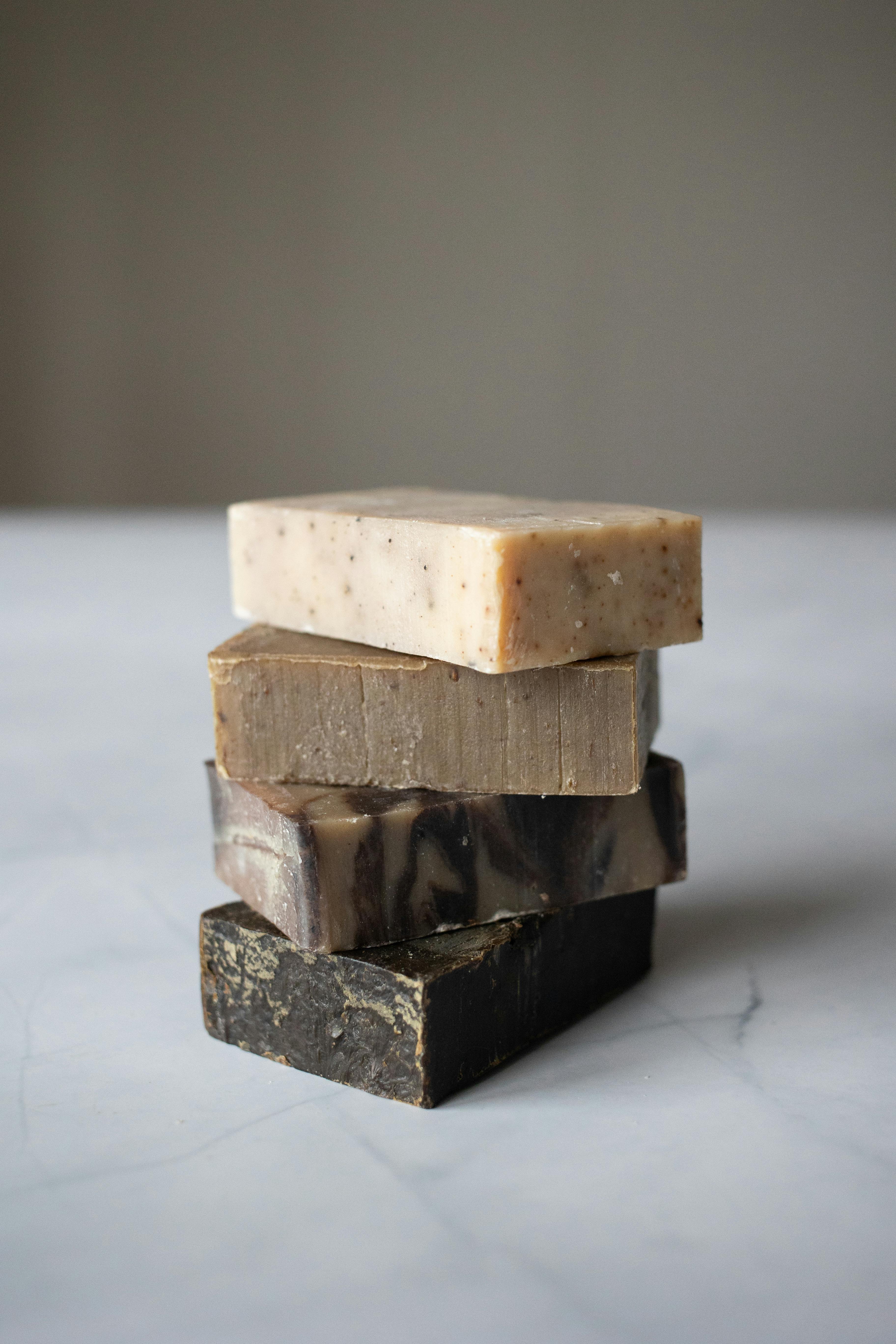 stack of natural soaps placed on light marble table