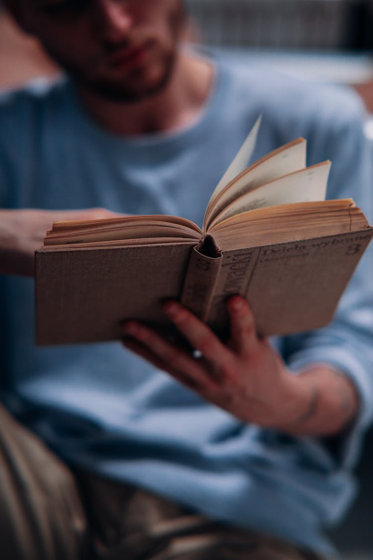 Close Up Photo Of A Man Reading A Book