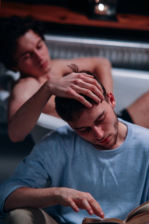 Free Photo of a Man in a Bathtub Touching a Man's Head Stock Photo
