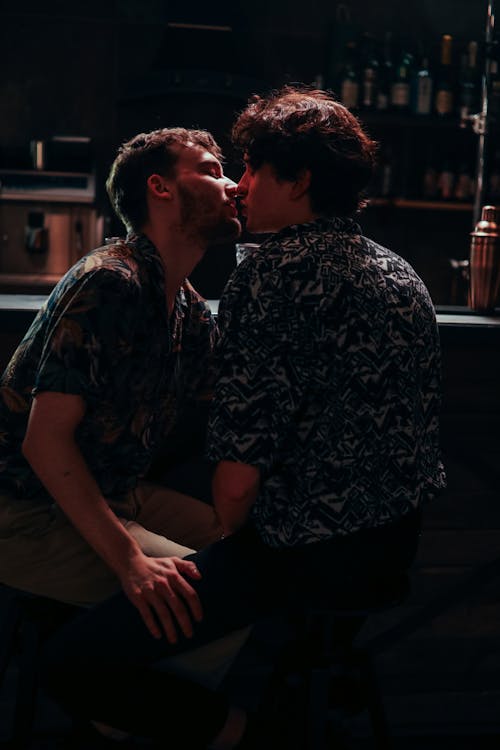 Free Romantic Couple kissing beside a Bar Counter  Stock Photo