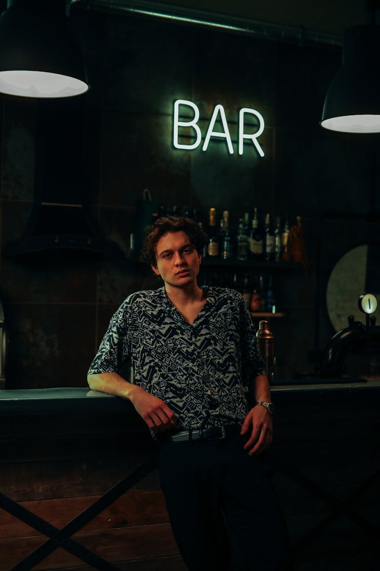 A Handsome Man Leaning On The Bar Counter