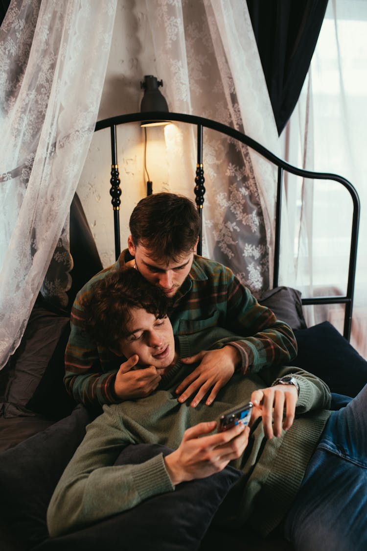 A Couple Looking At A Phone