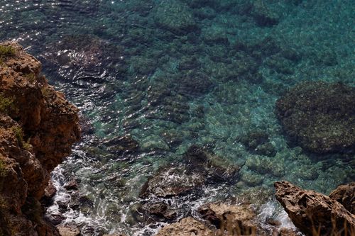 Free Explore the stunning turquoise waters and rugged rocks along the seashore of Antalya, Turkey, showcasing nature's beauty. Stock Photo