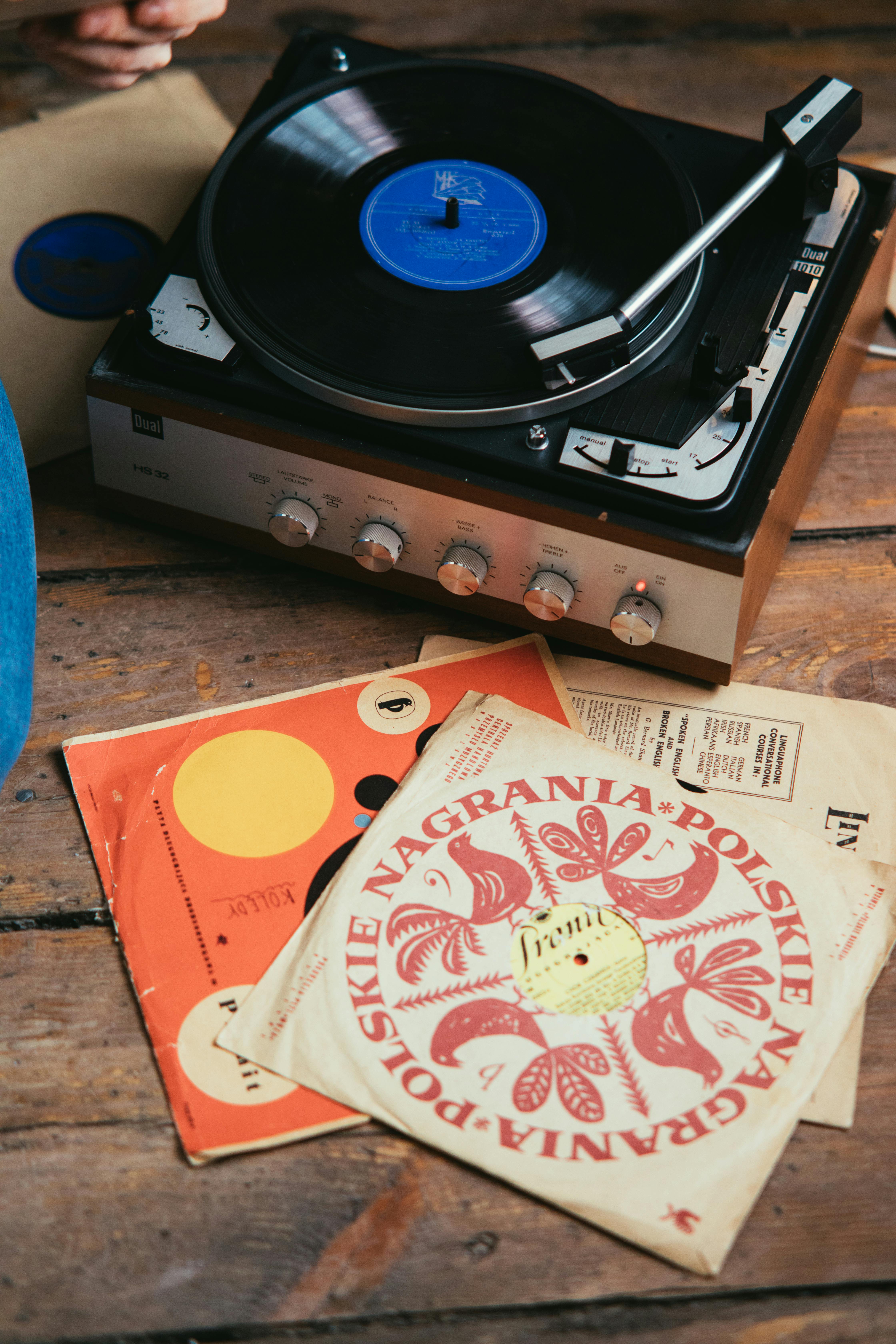 person playing music with a vinyl record