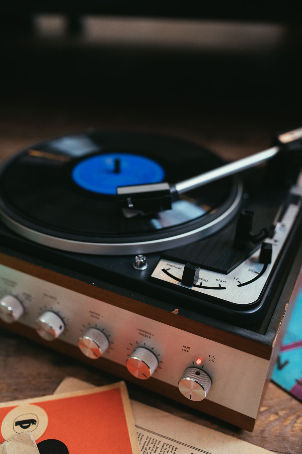Silver vinyl record player in a retro setting, evoking nostalgic music listening