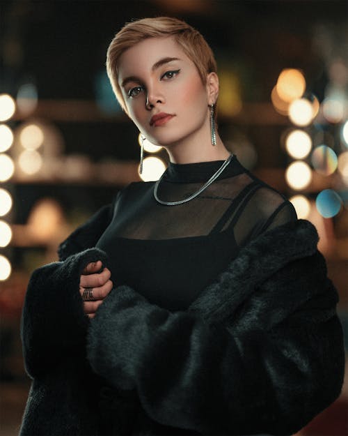 Woman in Black Fur Coat and Silver Jewelry at Night