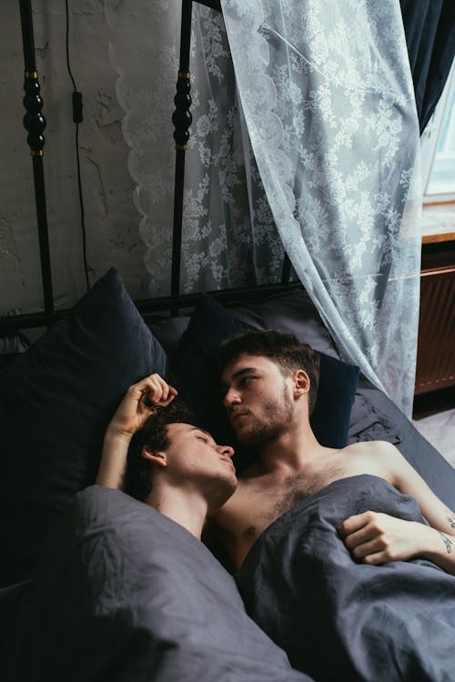 Free Affectionate Couple lying on Bed Stock Photo