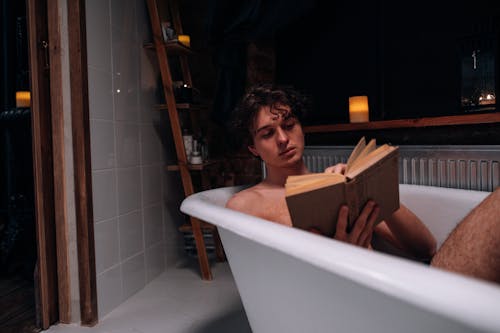 Man Reading a Book in the Bathtub