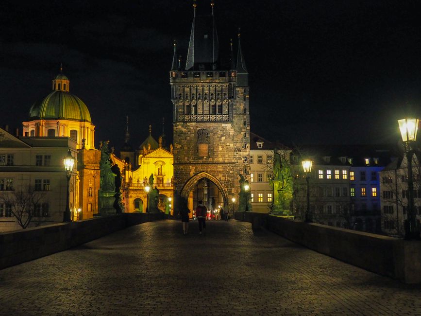 Charles Bridge illuminated at night showing gothic architecture