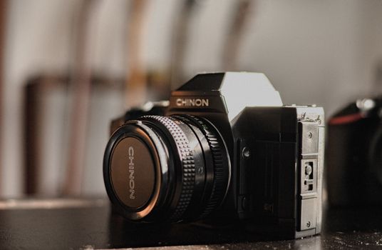Close-up image of a Chinon film camera, perfect for photography enthusiasts.