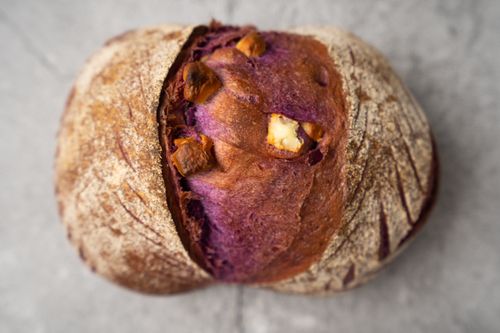 Free Top view of a rustic purple sweet potato bread loaf with nuts. Stock Photo