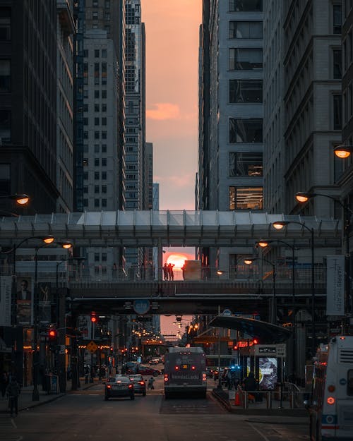 Foot Bridge Over Road Between Buildings at Sunset