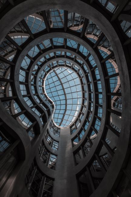 Intricate spiral glass dome in a modern building, showcasing geometric elegance and innovative design in Barcelona, Spain.