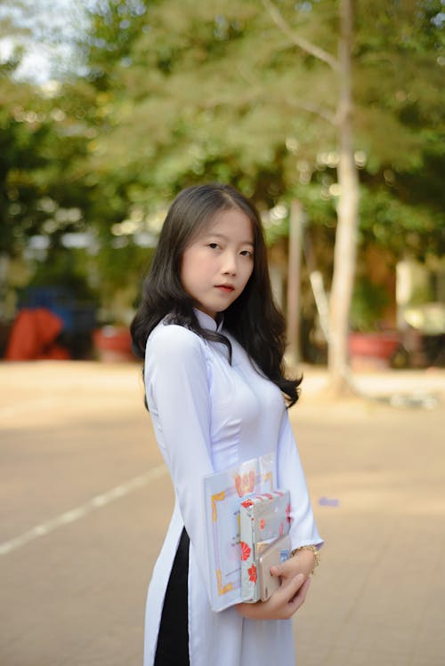 A Girl Wearing a White Ao Dai Dress