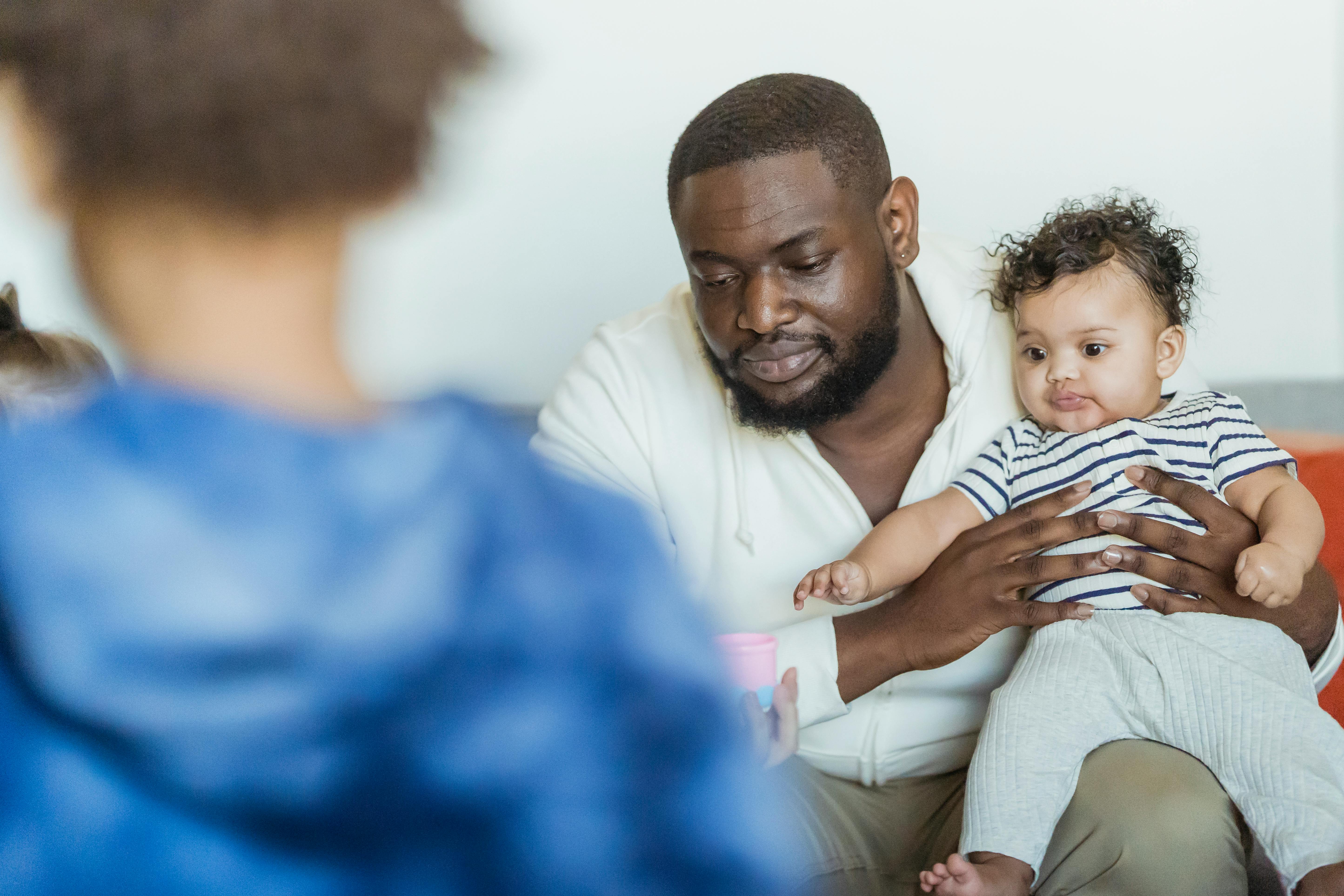 black father with anonymous children spending time at home