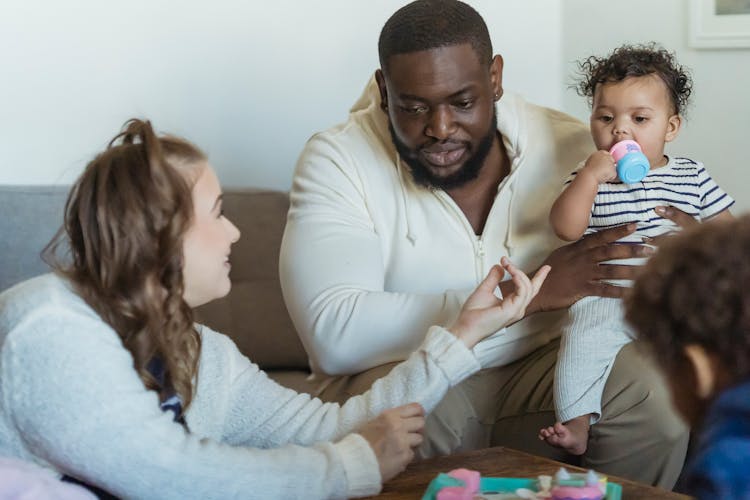 Crop Diverse Family Talking In Living Room