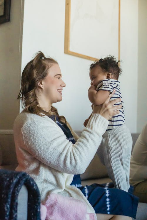 Free Optimistic mother with black baby in hands Stock Photo