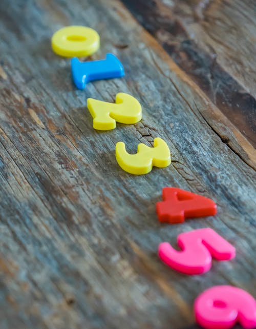 Multicolored numbers for counting on wooden table